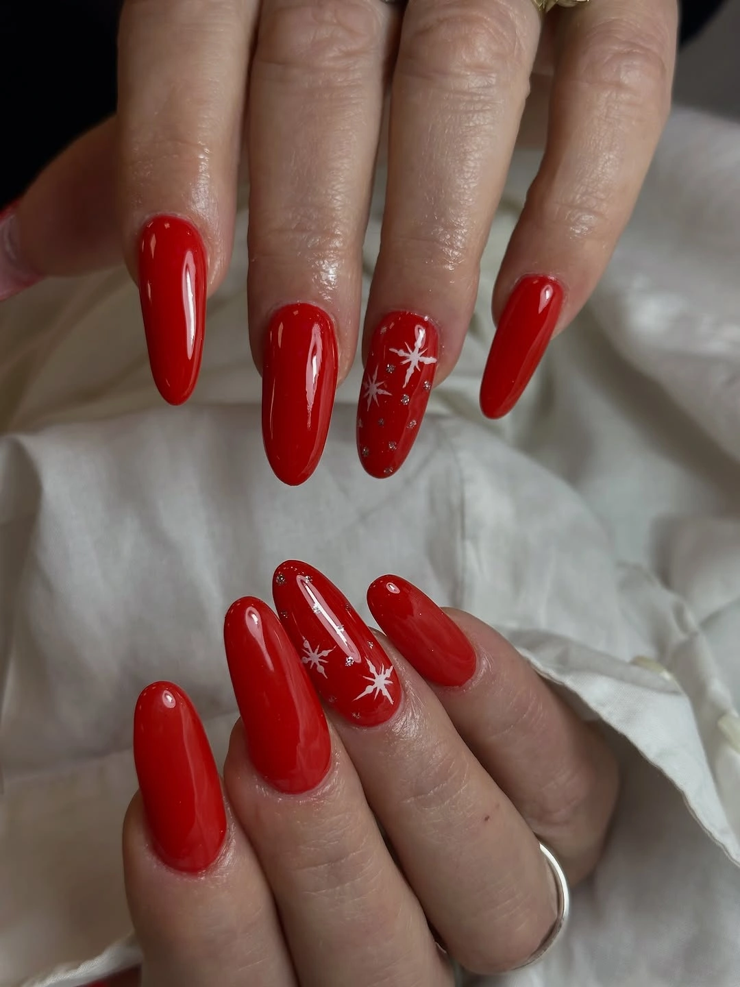 Very long pointed nails in vivid glossy bright red