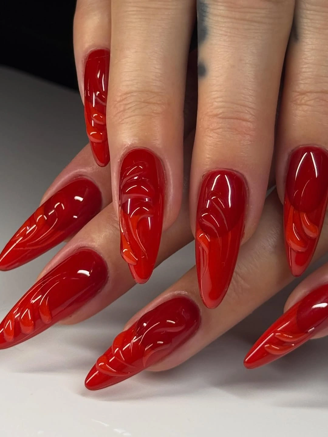 Square red glitter nails with pale pink bow accents