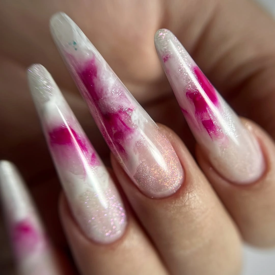 Long translucent almond nails with fuchsia patches and milky shimmer
