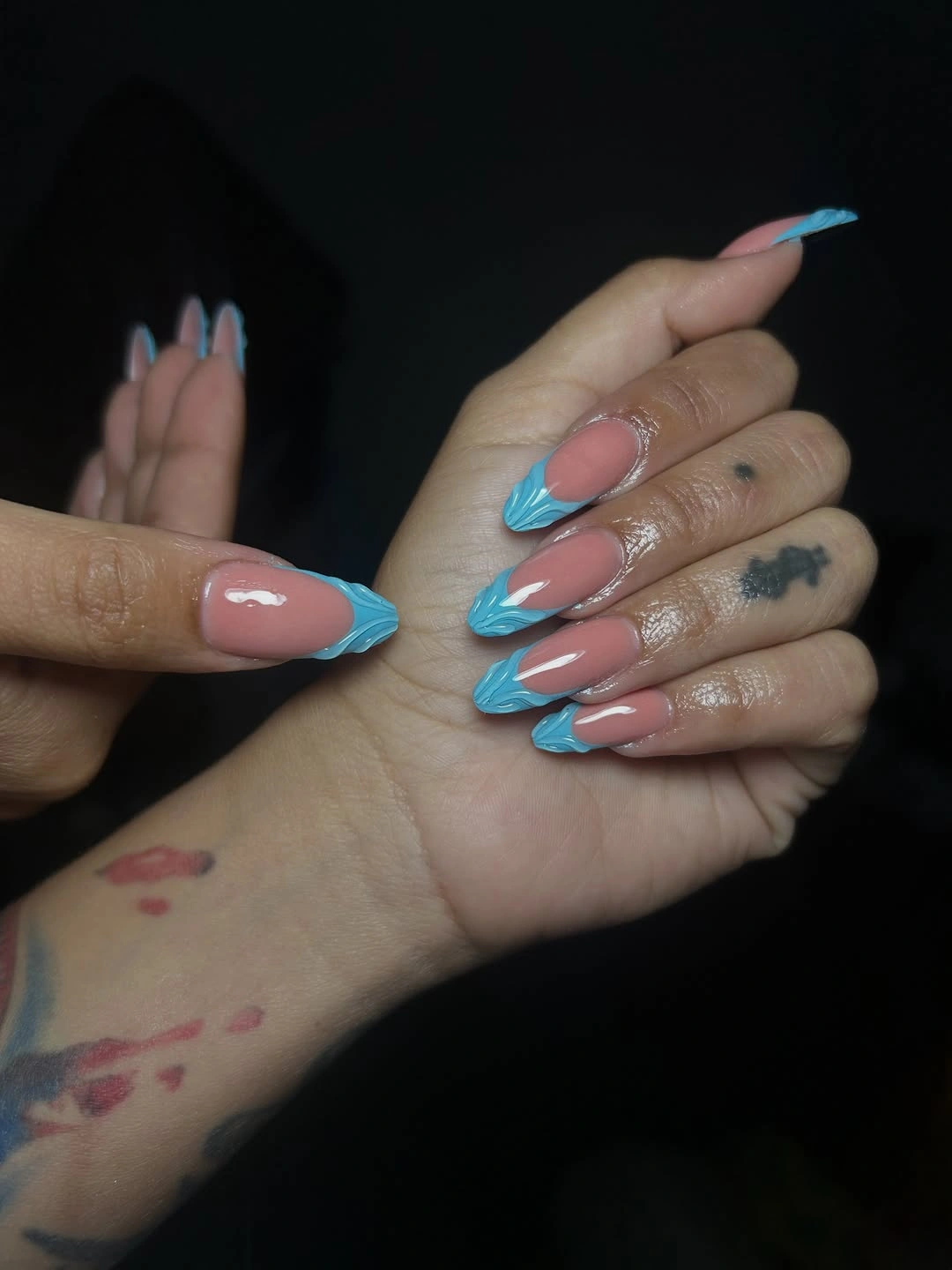 Glossy pink almond nails with bright aqua layered tips