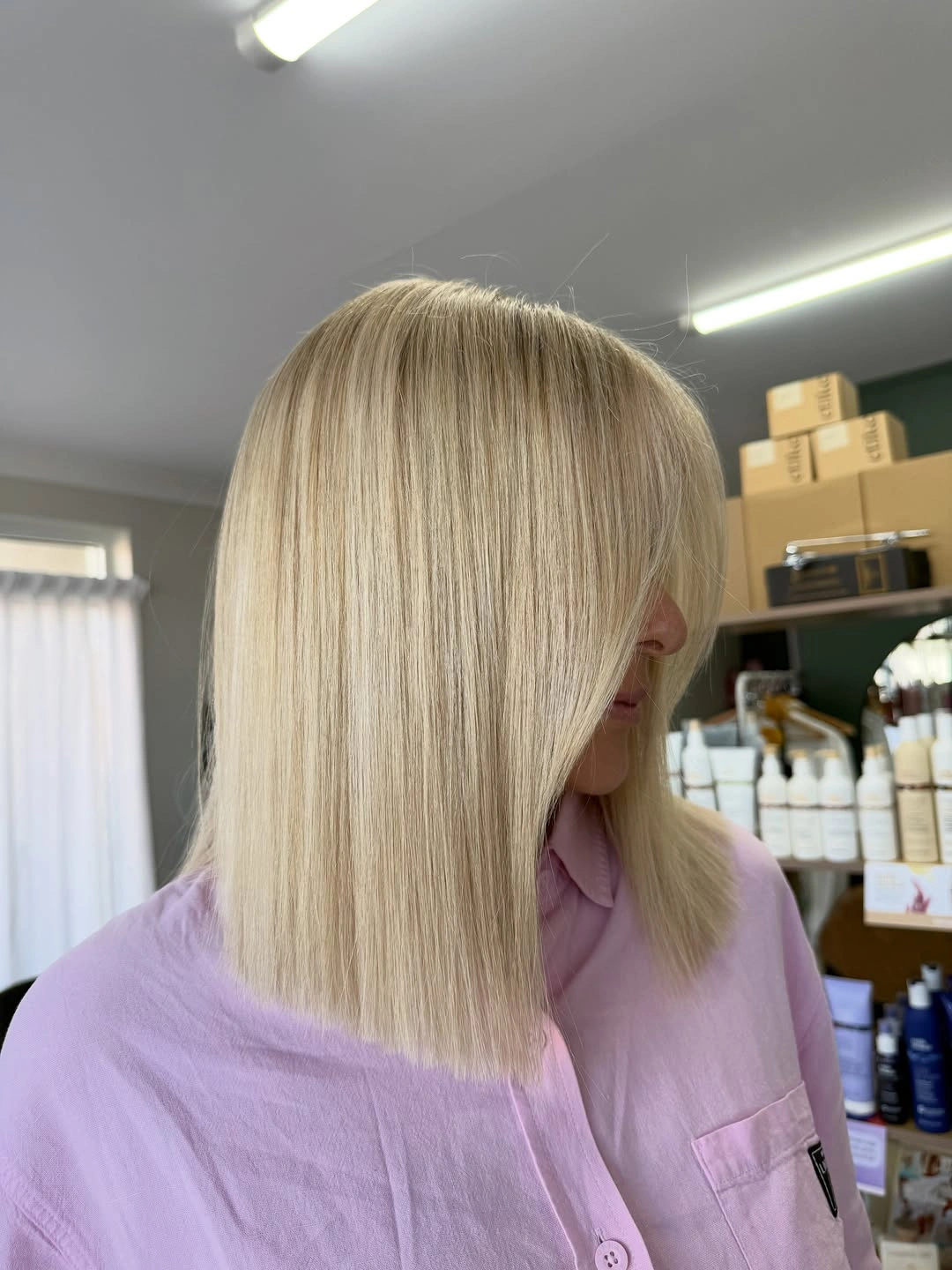 Pale blonde blunt bob with side-falling front section