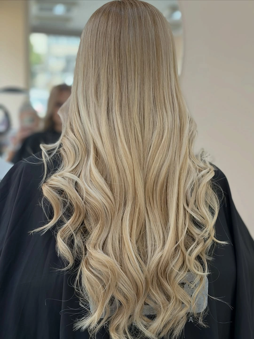 Very long blonde hair with smooth crown and curled lower lengths