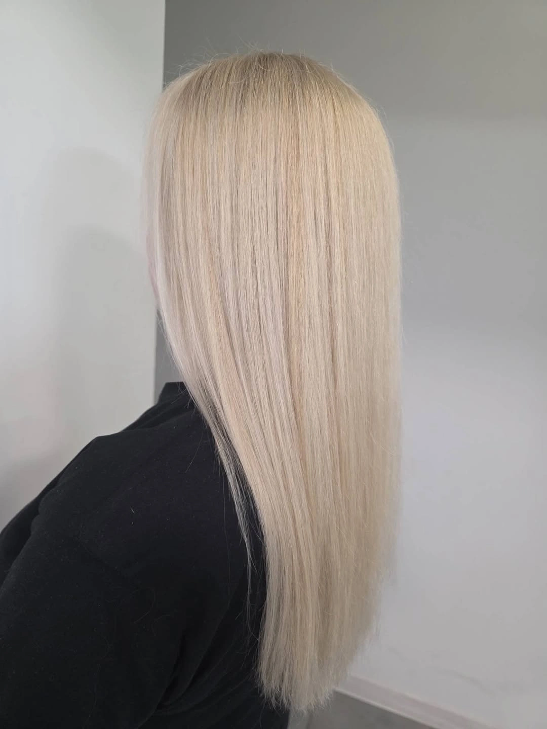 Long straight pale blonde hair with minimal roots and soft blunt ends