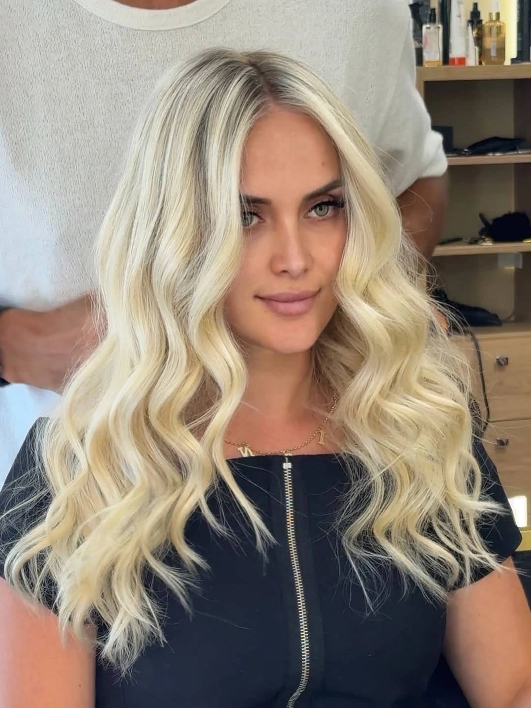 Long creamy blonde waves with dark roots and bright face framing
