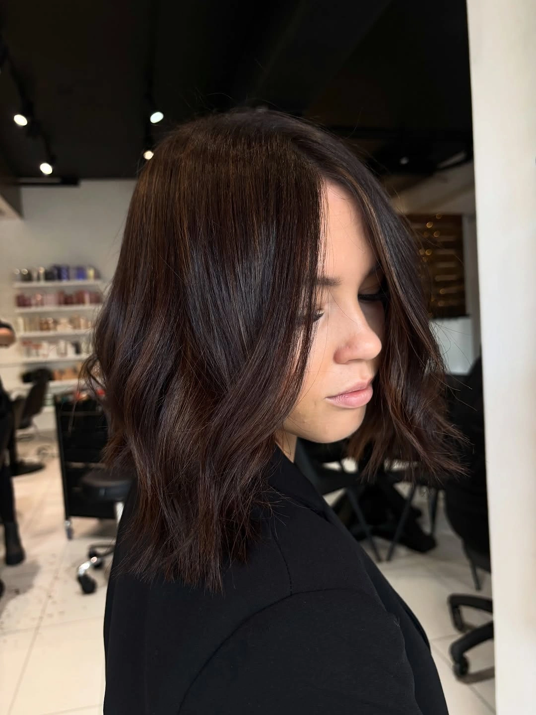 Medium brunette lob with soft waves and warm shine