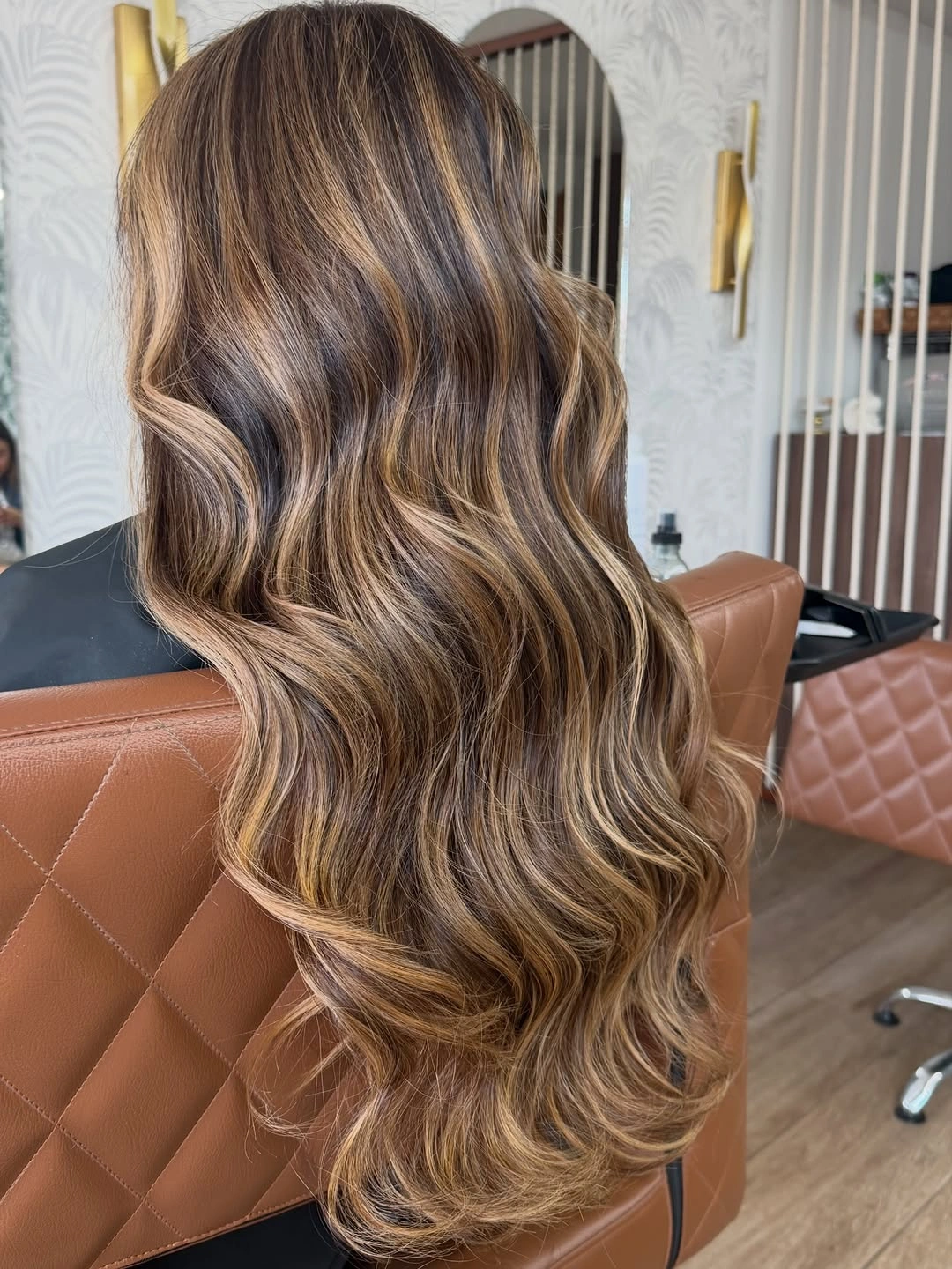 Long wavy brunette hair with beige caramel highlights