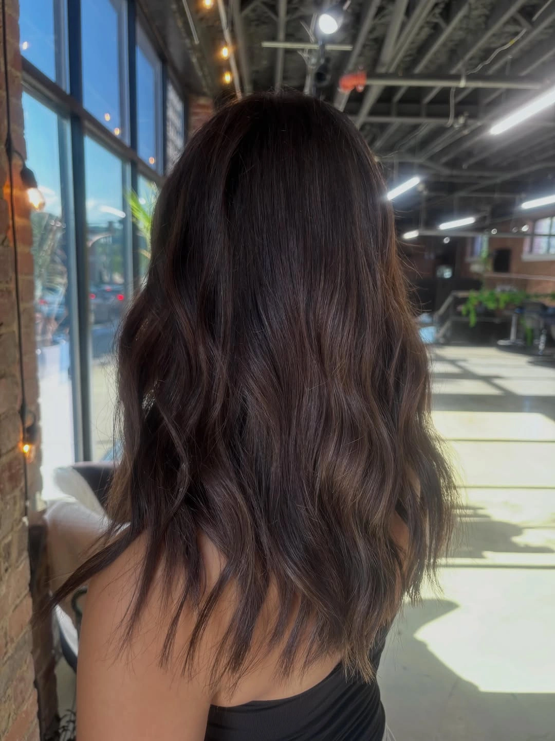 Medium-length dark brunette waves with cool muted shine