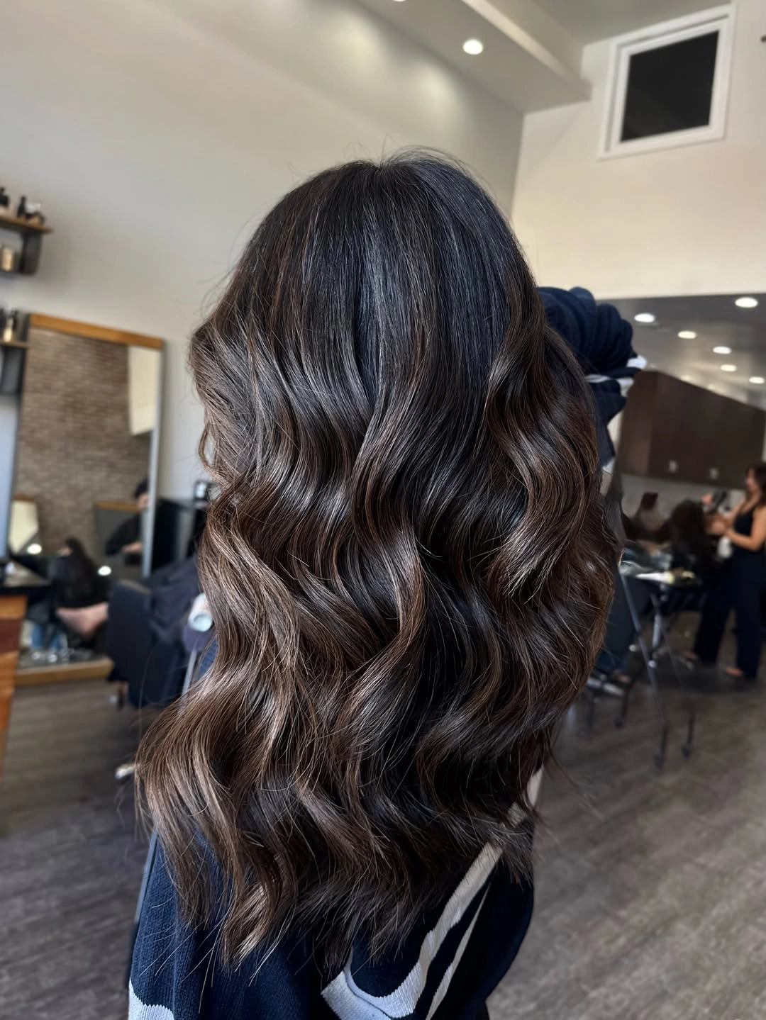 Dark brunette waves with cool glossy beige reflections