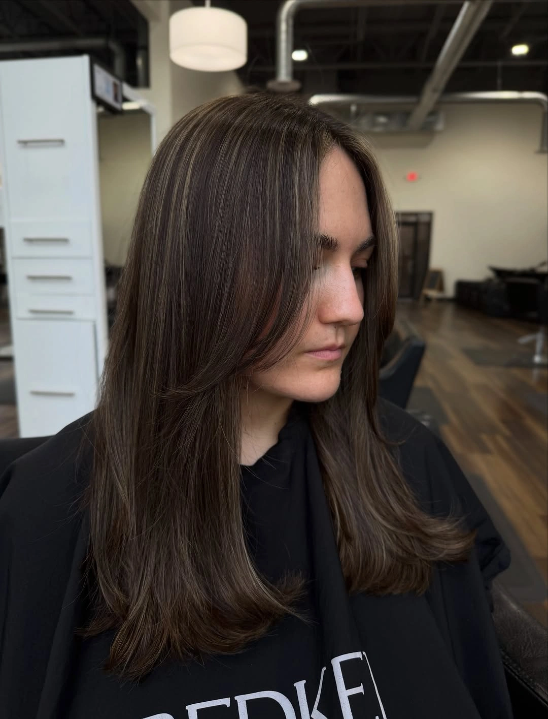 Smooth medium brunette hair with fine cool beige highlights