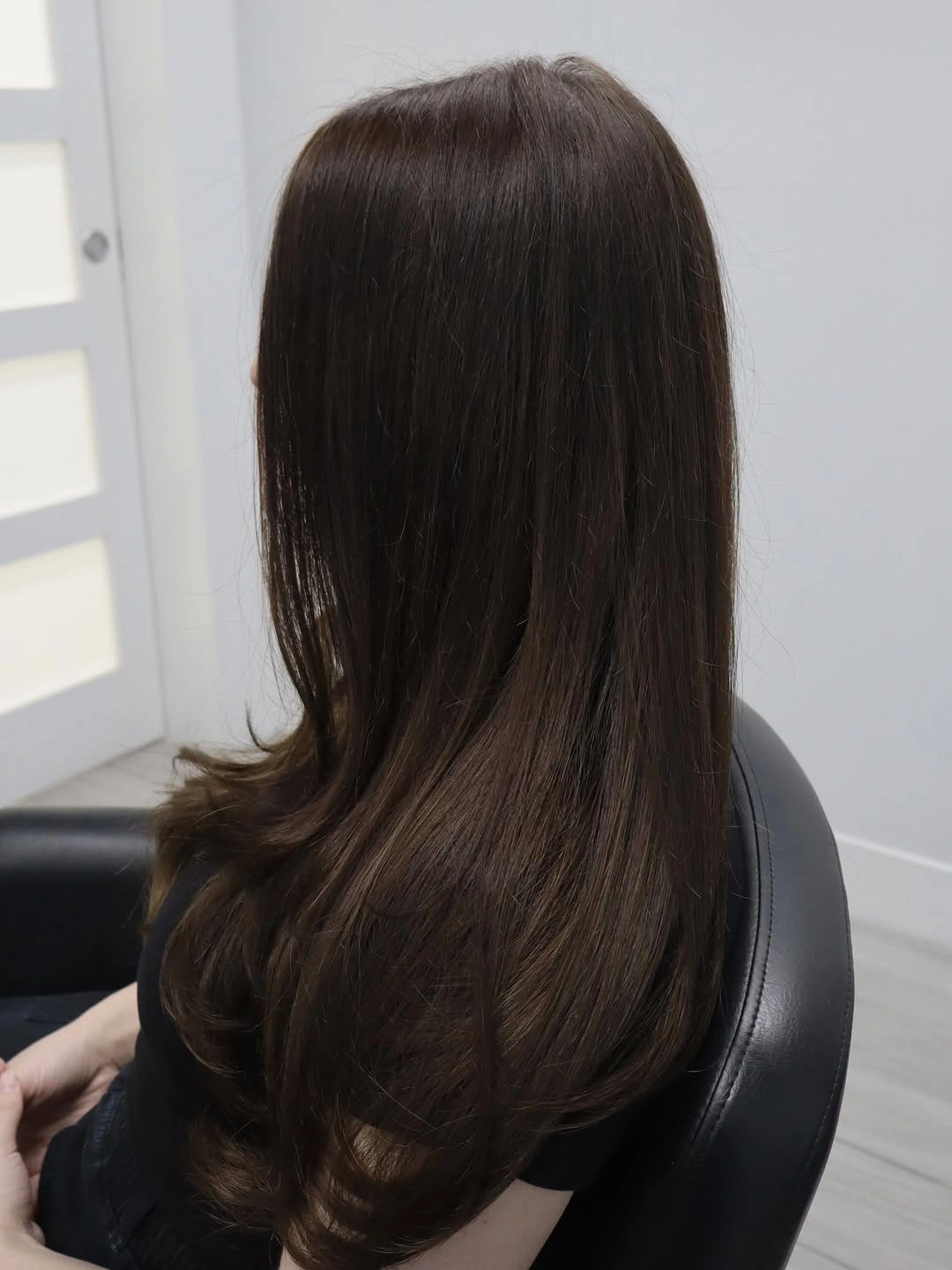 Long dark chocolate brunette hair with curved-under ends