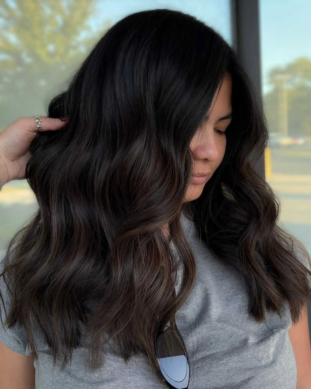 Medium dark brunette waves with side-swept mocha edges