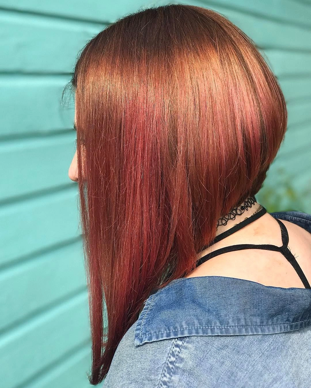 Copper-red angled bob with glossy back and very long front panel