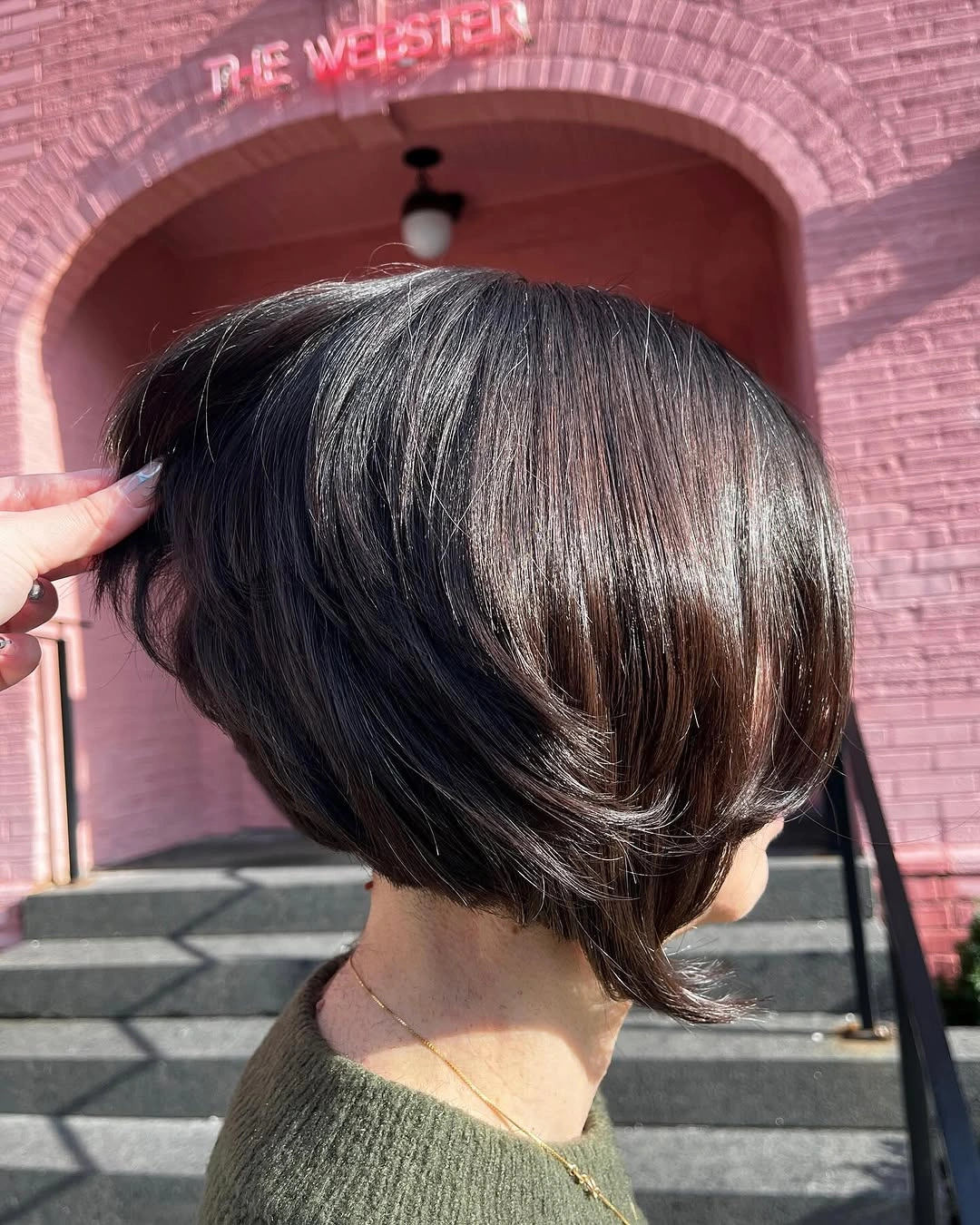 Short dark stacked bob with rounded back and flipped lower side pieces