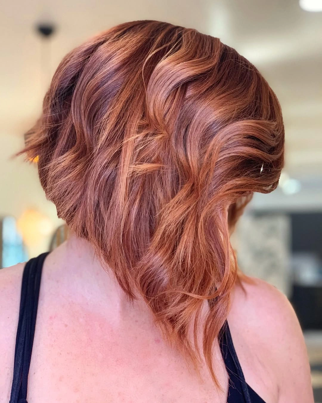 Copper wavy graduated bob with tousled back and longer side curl
