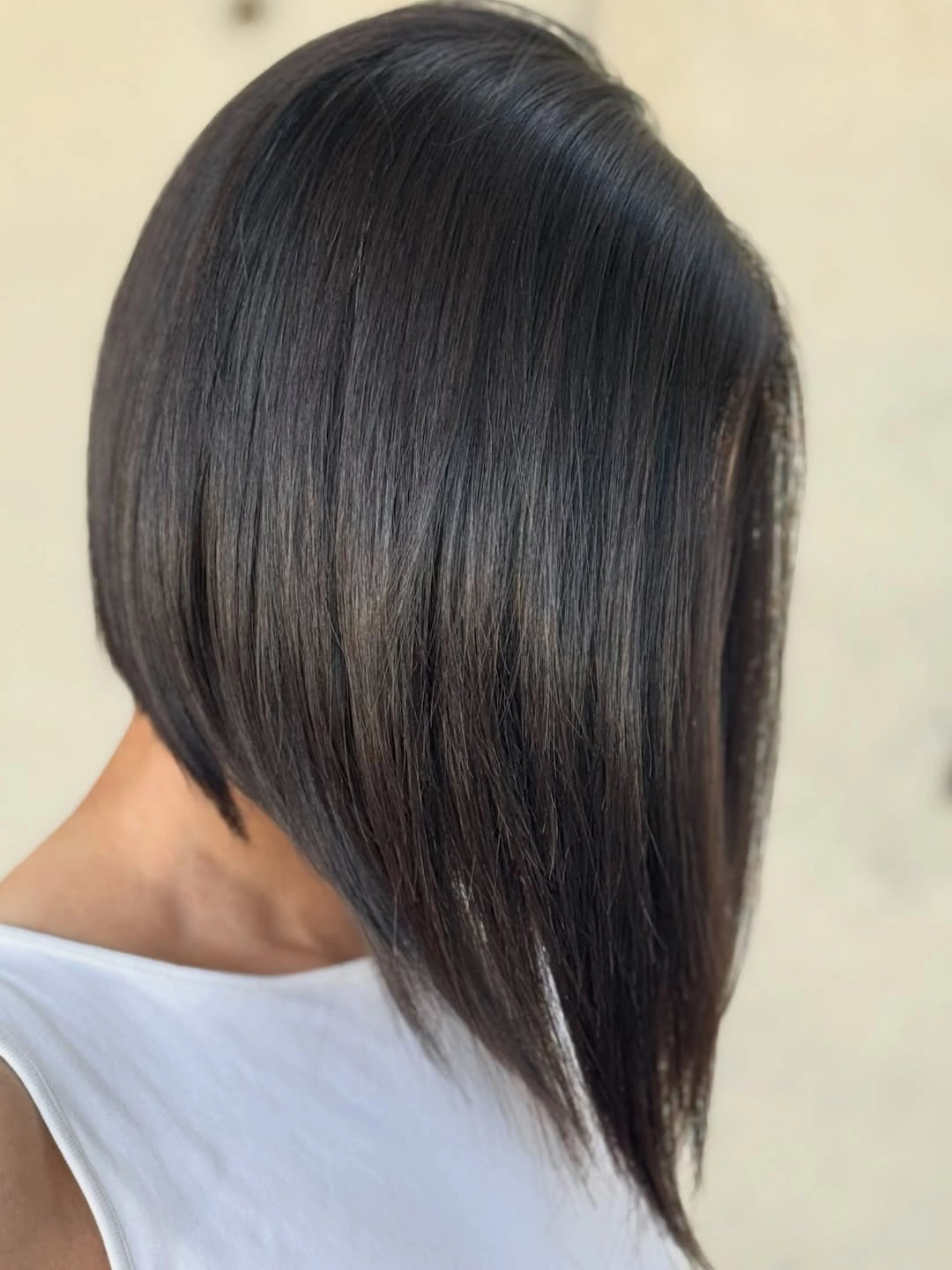 Sleek dark long A-line bob with short nape and descending front
