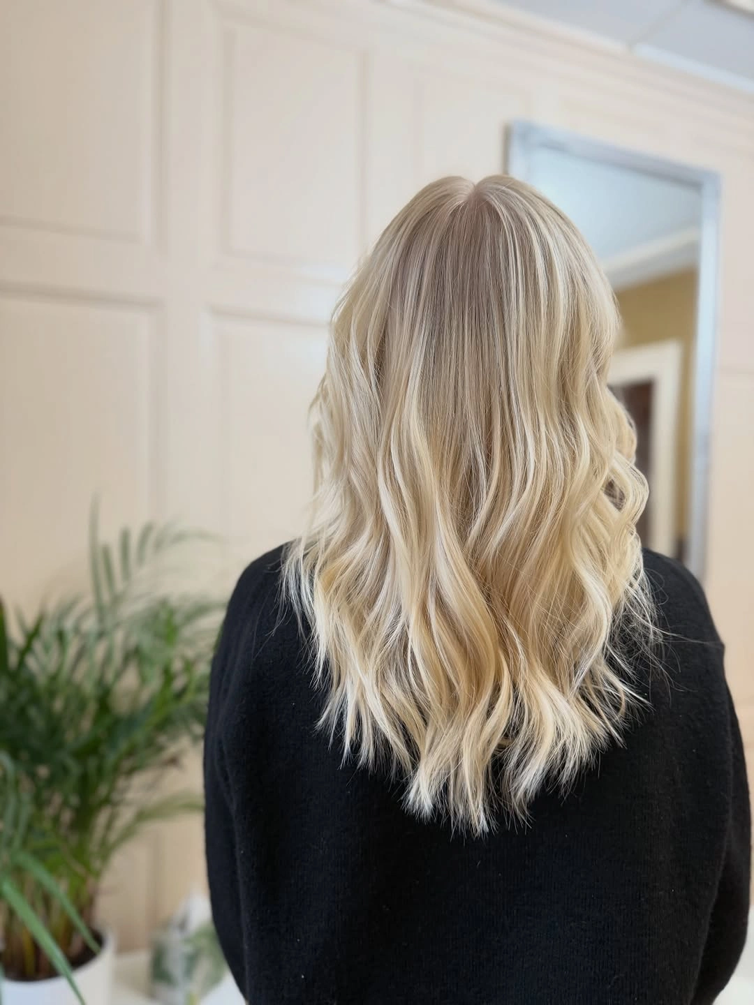 Back view of medium long cream beige blonde waves