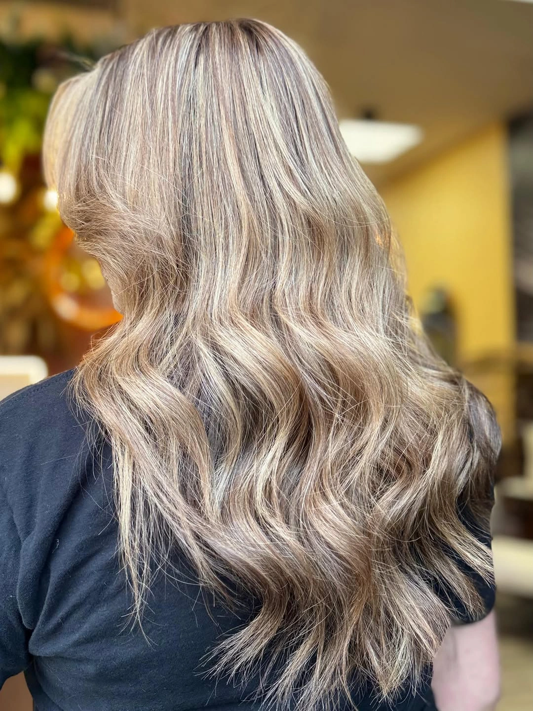 Back view of taupe ash blonde waves with pale ribbons