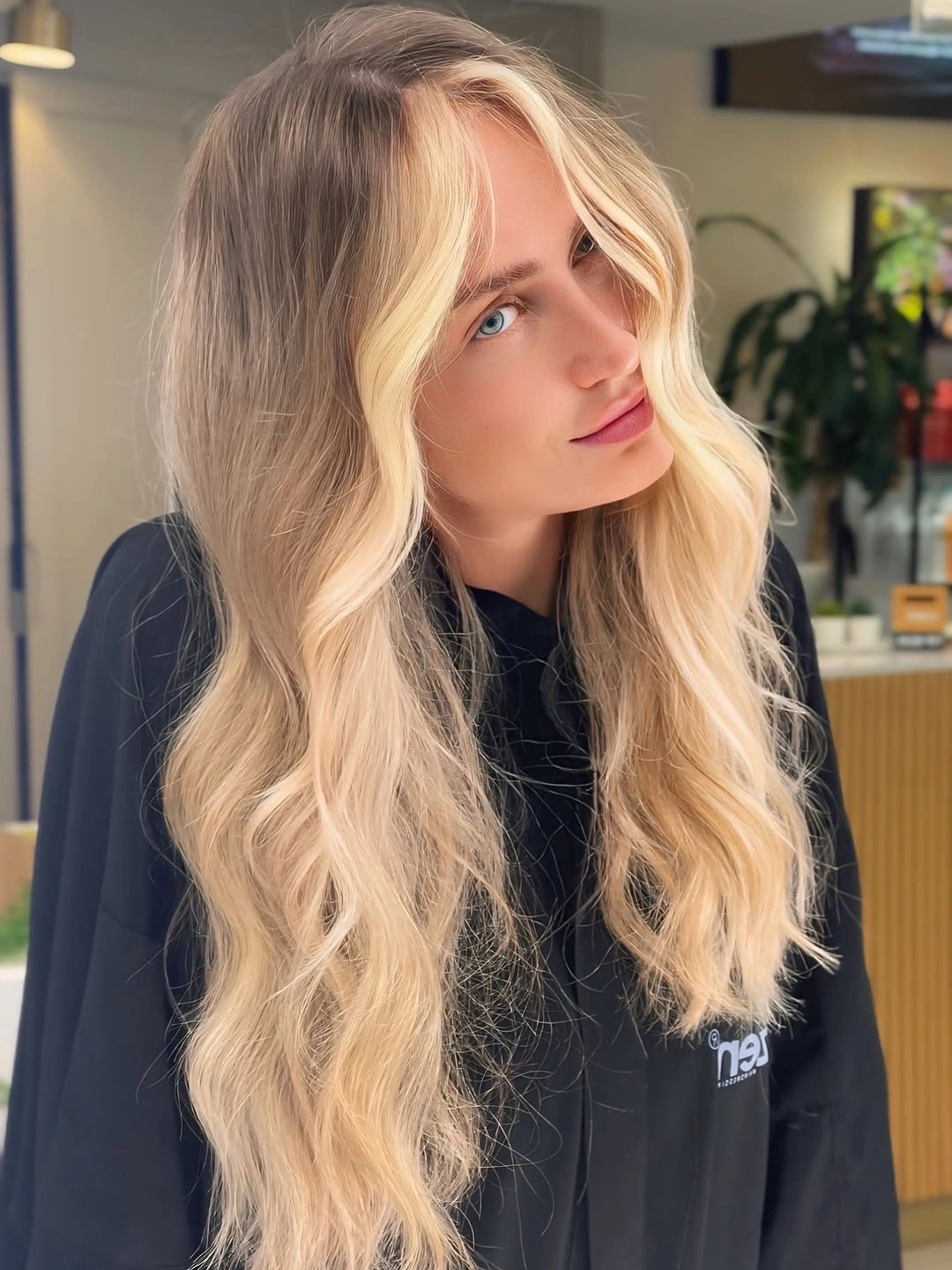Long blonde waves with darker roots and bright front pieces