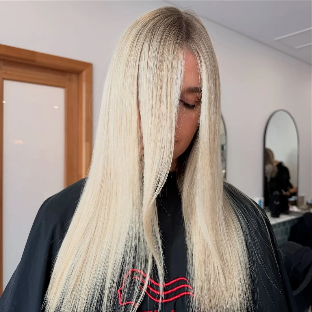 Long straight pale blonde panels with dark root line