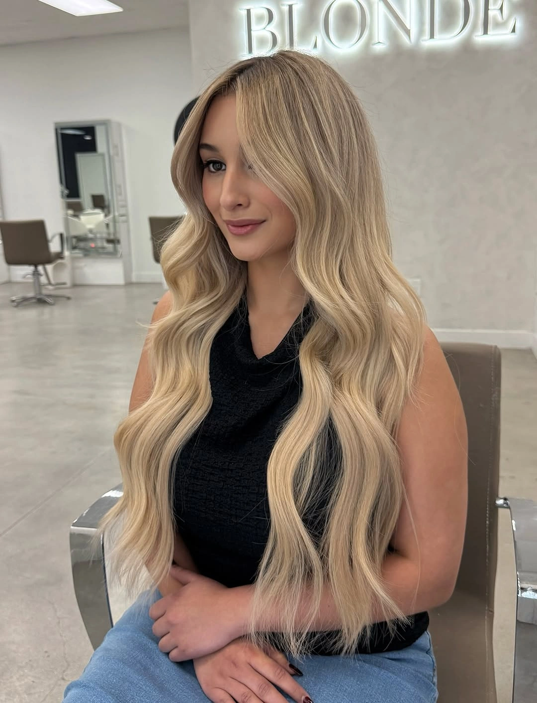 Very long pale blonde waves with center part and dark top