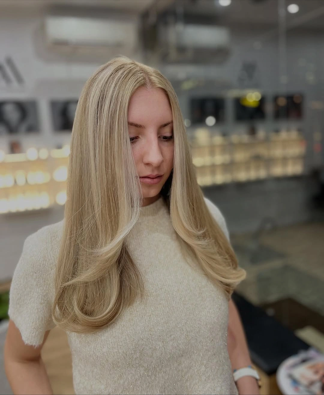 Long beige blonde with smooth crown and curled face layers