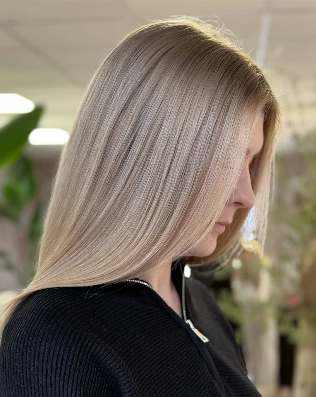 Side view of sleek dark beige blonde with pale ends