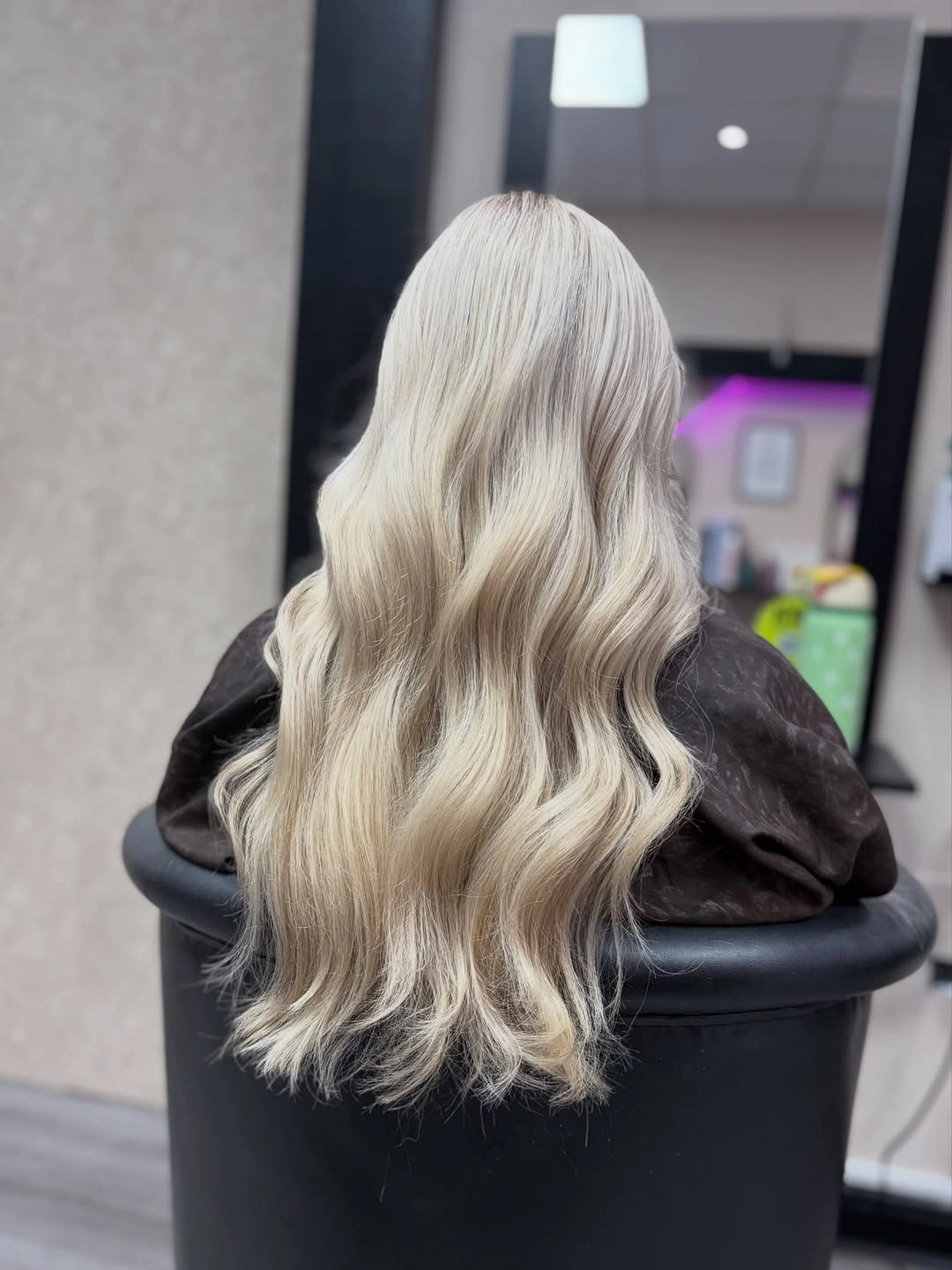 Icy pale blonde waves against dark clothing