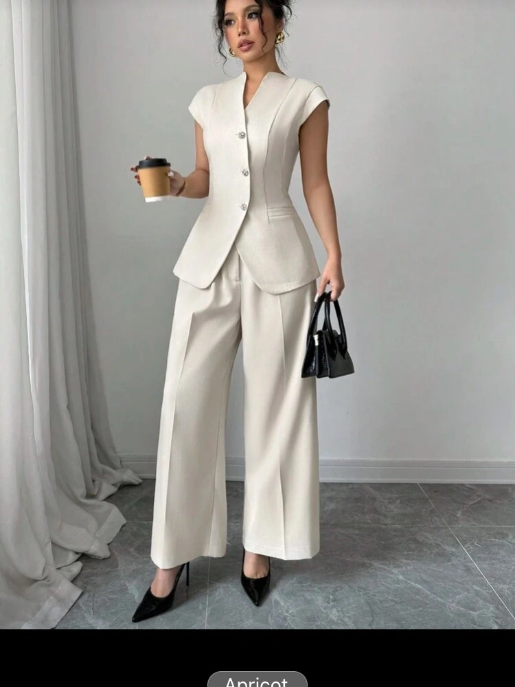 Ivory fitted cap-sleeve top and cropped wide-leg trousers with black pumps and handbag.