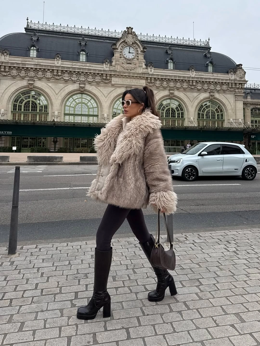 Long taupe textured coat with black leggings and knee boots