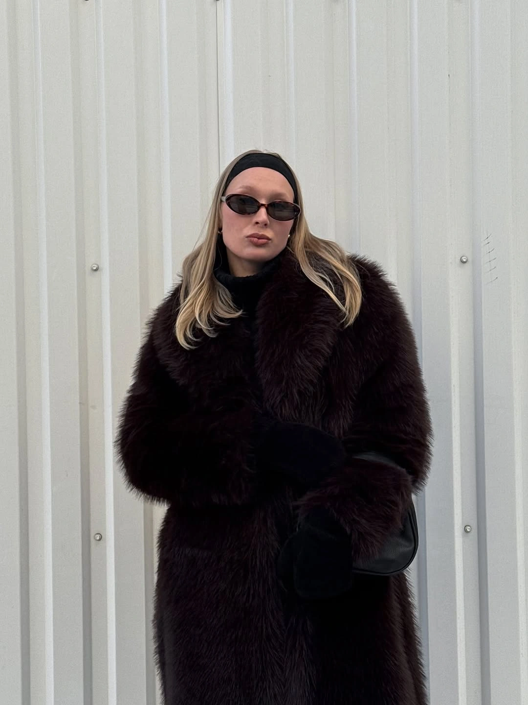 Oversized dark brown textured coat with a headband and sunglasses
