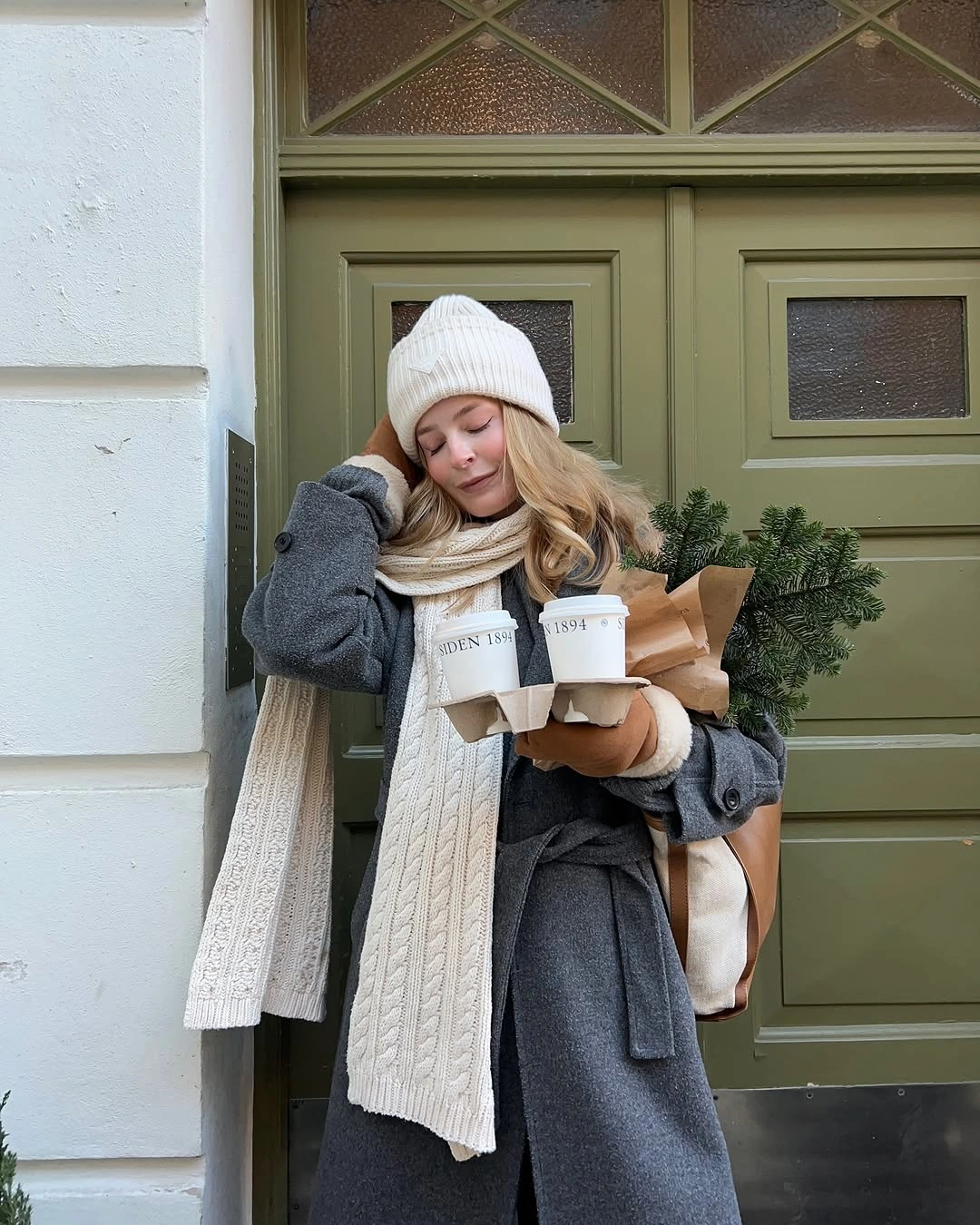 Gray belted coat, cream beanie, long scarf, and tan gloves