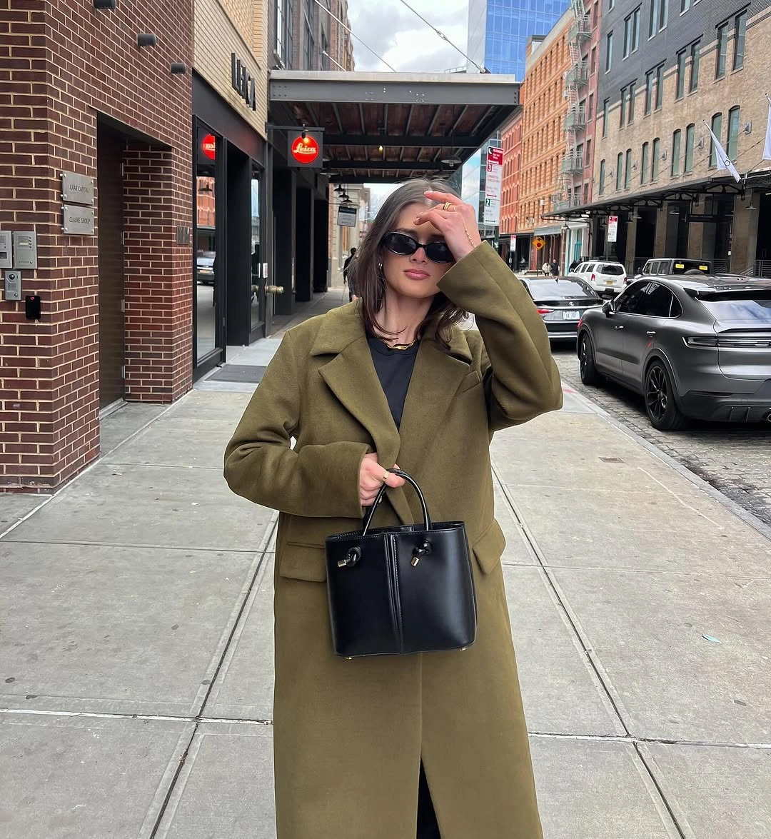 Olive long coat, black top, wide black pants, structured black tote