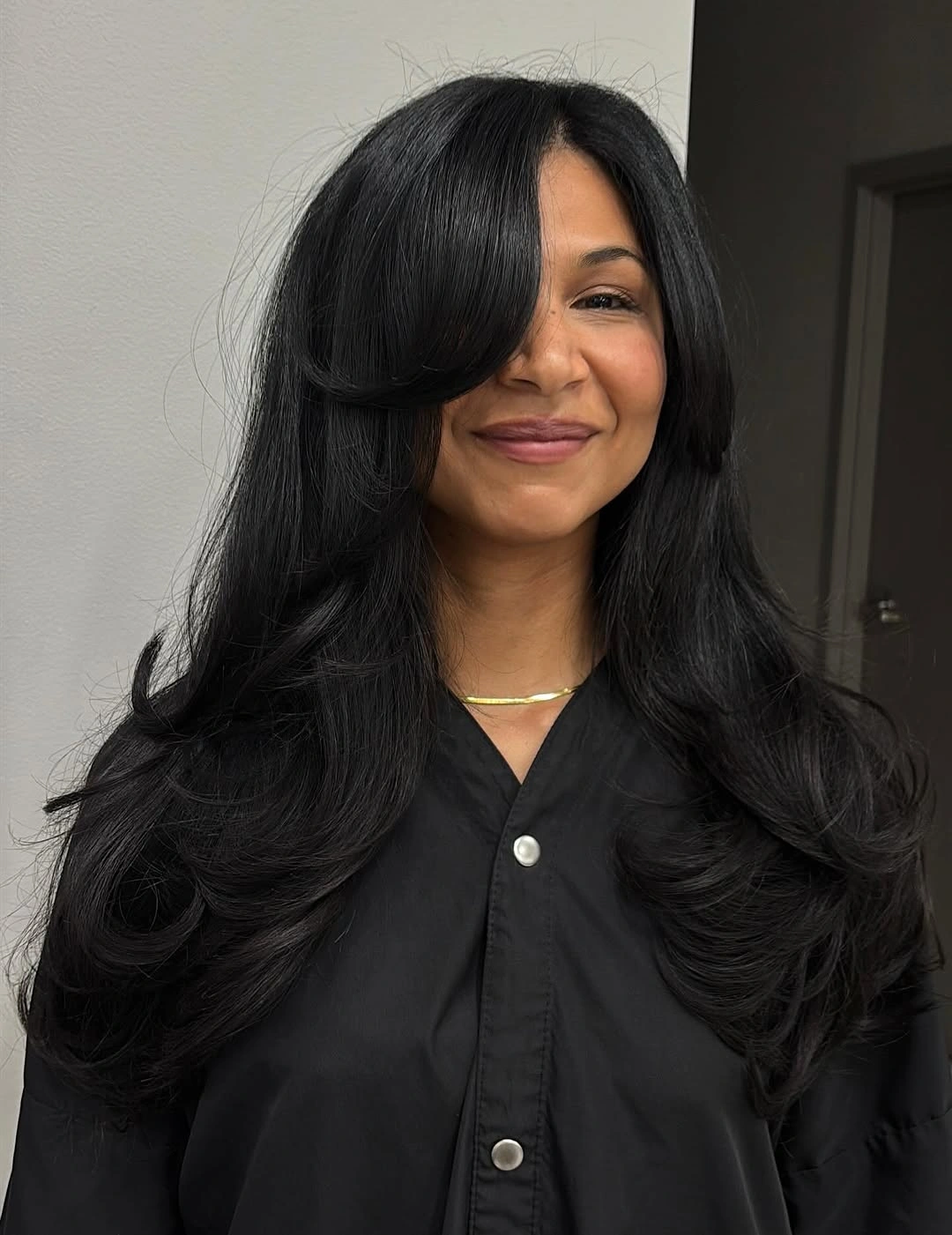Long black layered hair with sweeping front layers