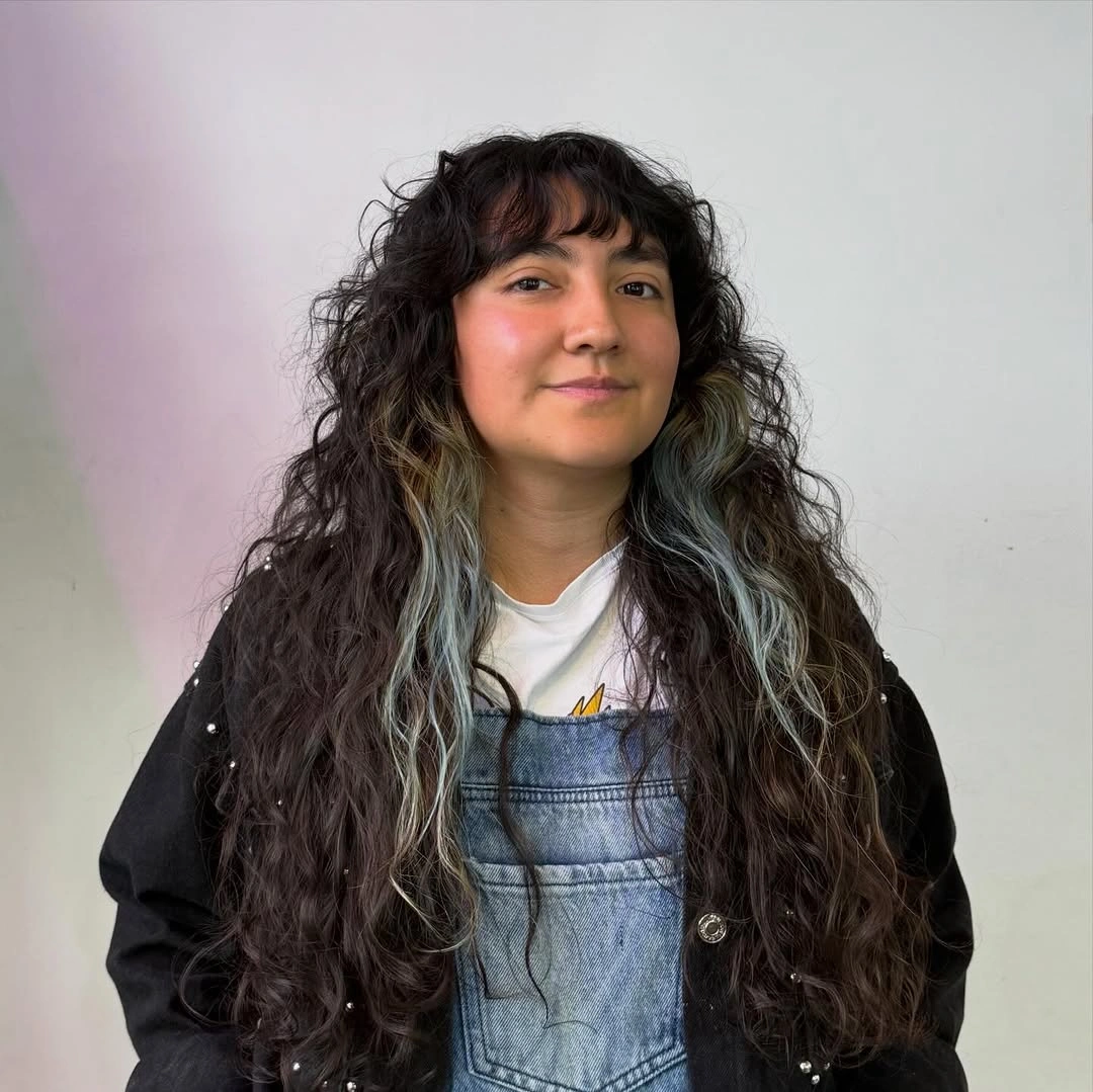 Very long dark curls with short curly bangs