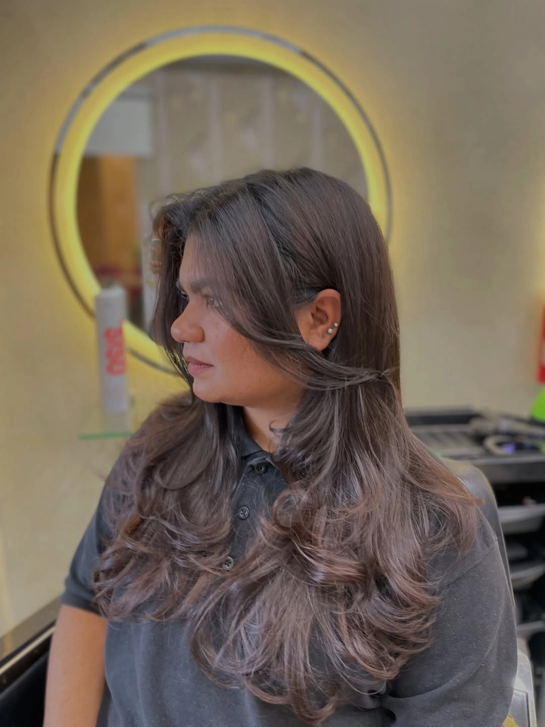 Medium-long brown hair with lower curved layered sections