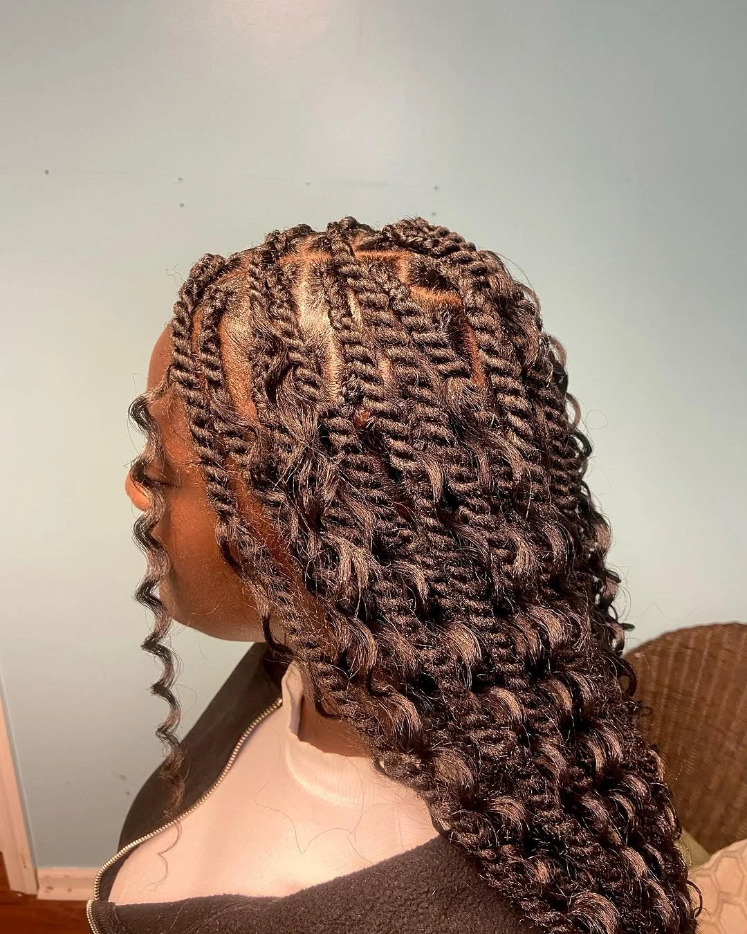 Brown rope-like twists with loose spiral curls and angular partings near the crown