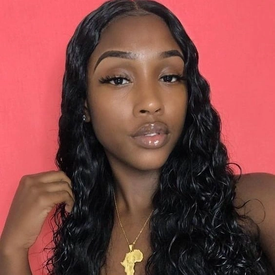 Long dark center-parted hair with narrow waves and loosely clustered lower curls
