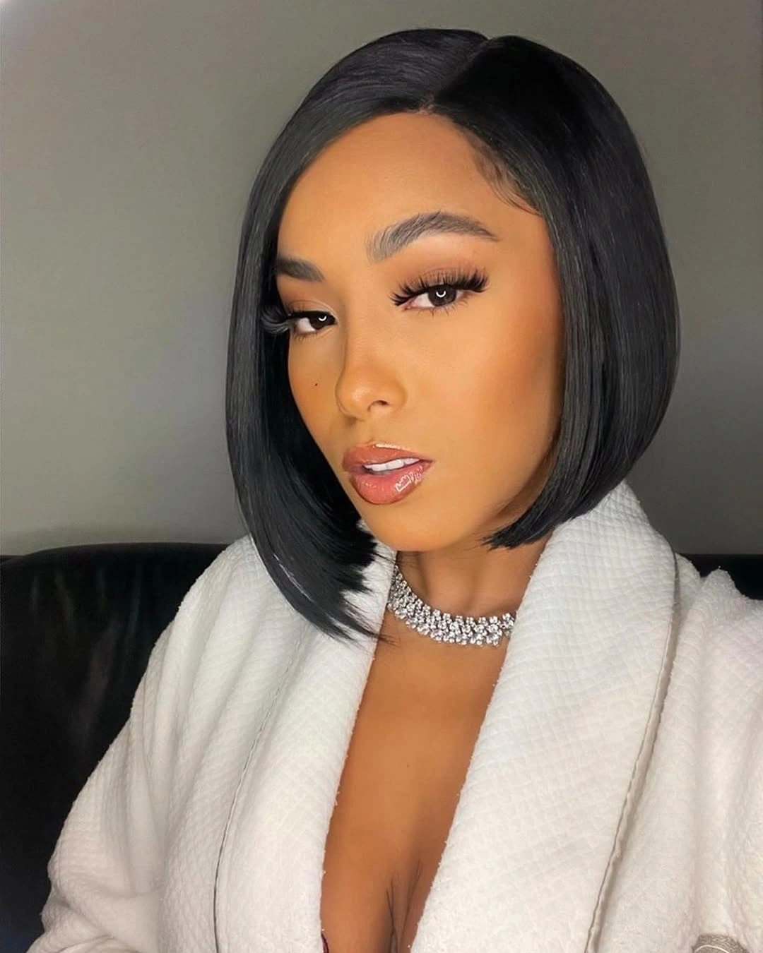 Smooth dark side-parted bob with one longer-looking front edge