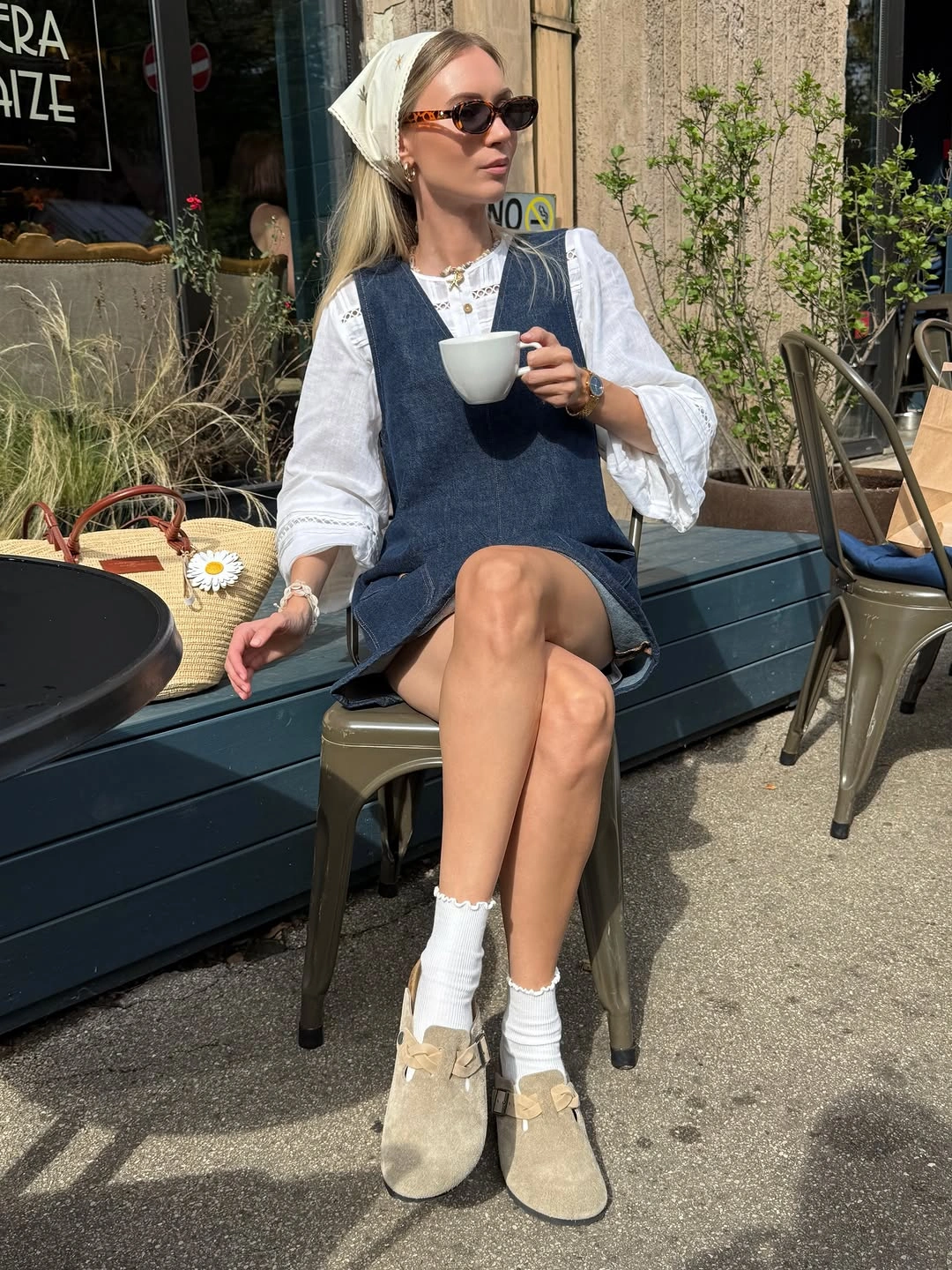 Dark denim sleeveless layer, white blouse, headscarf, socks, and tan shoes