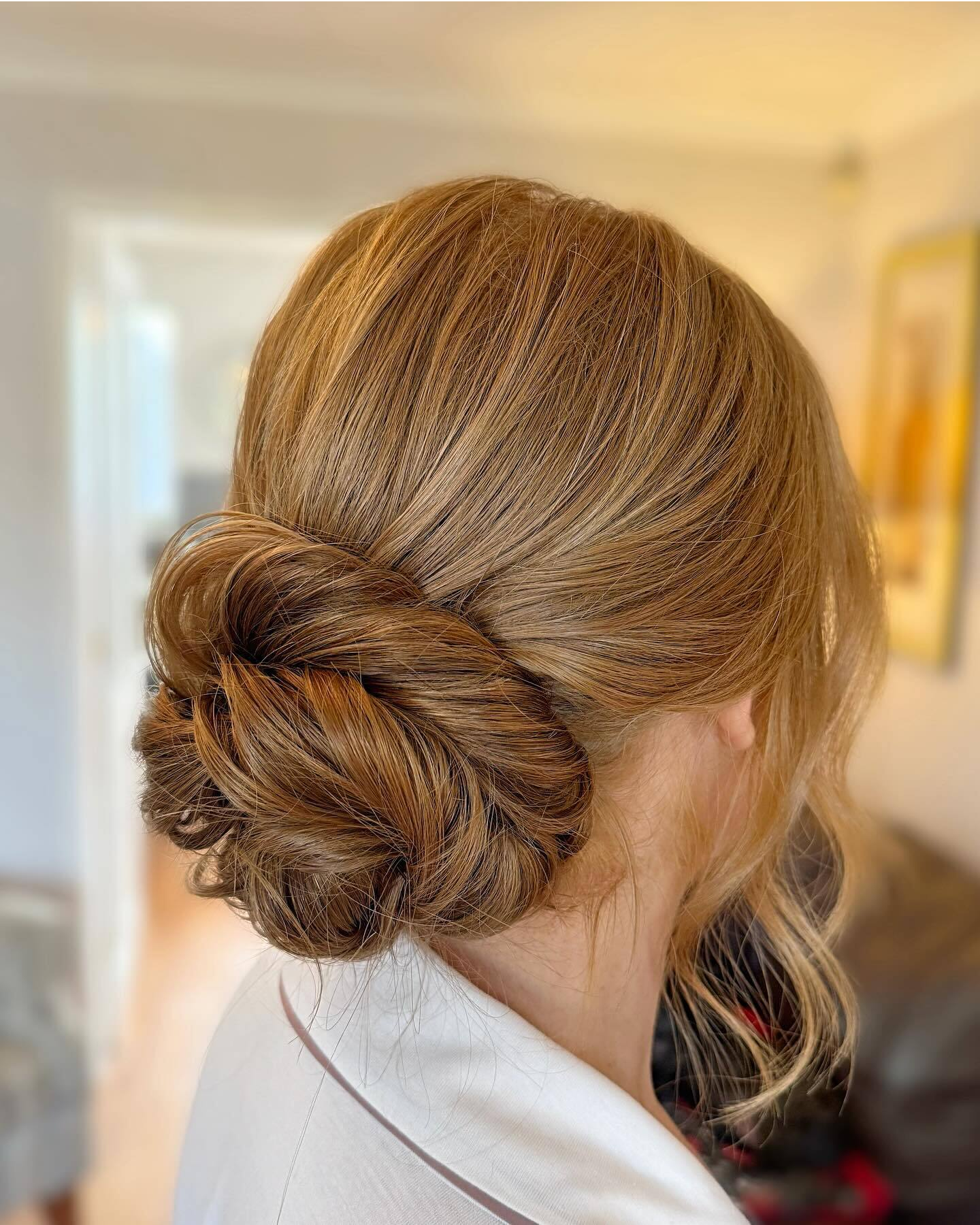 Elegant Honey Blonde Chignon — Winter Hairstyles for Women Over 50