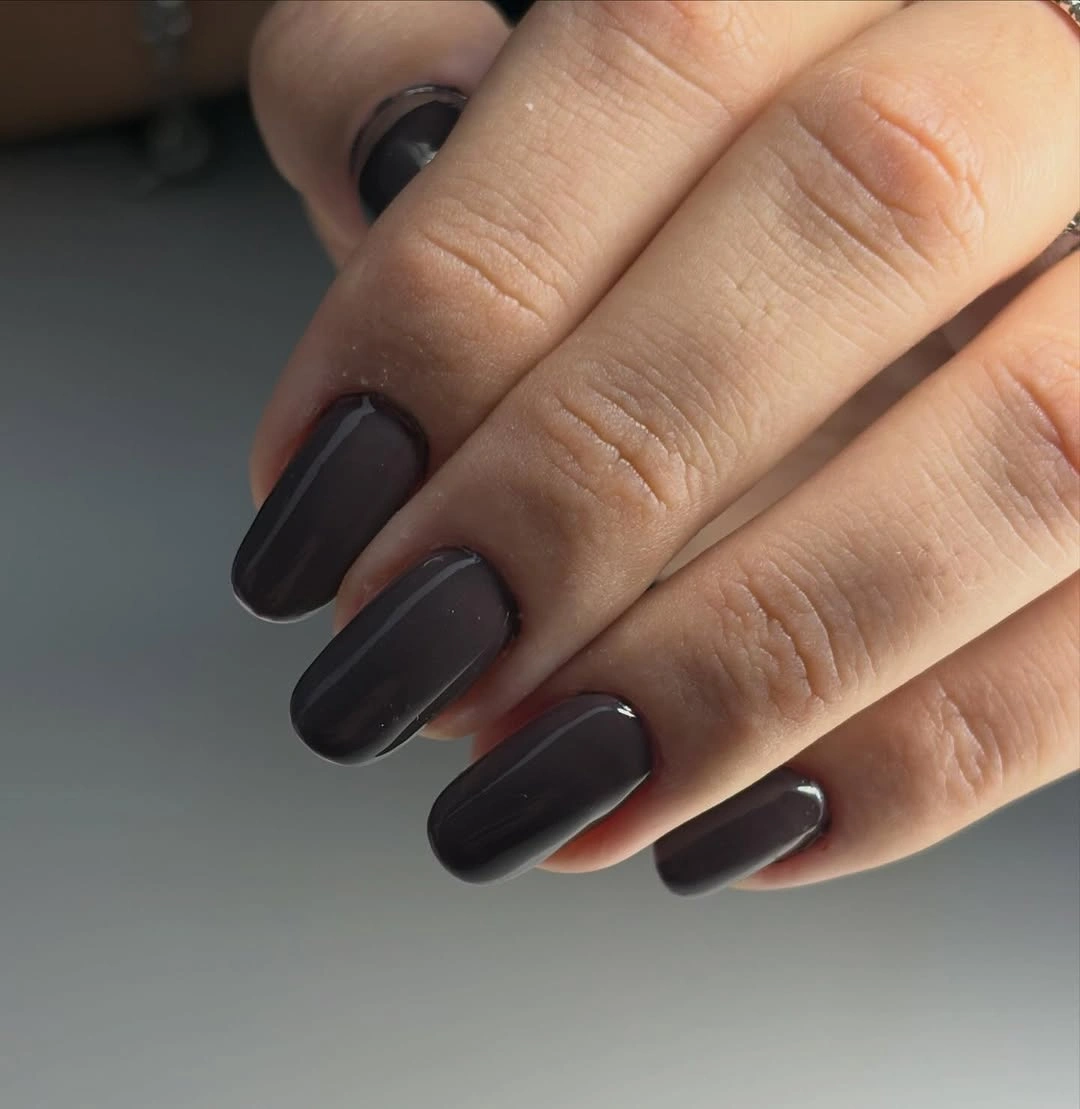 Short square nails in glossy deep charcoal polish