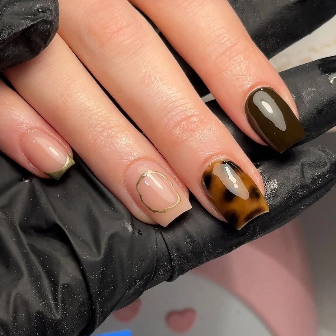 Square nails with olive-brown polish, nude outlines and tortoiseshell-like pattern