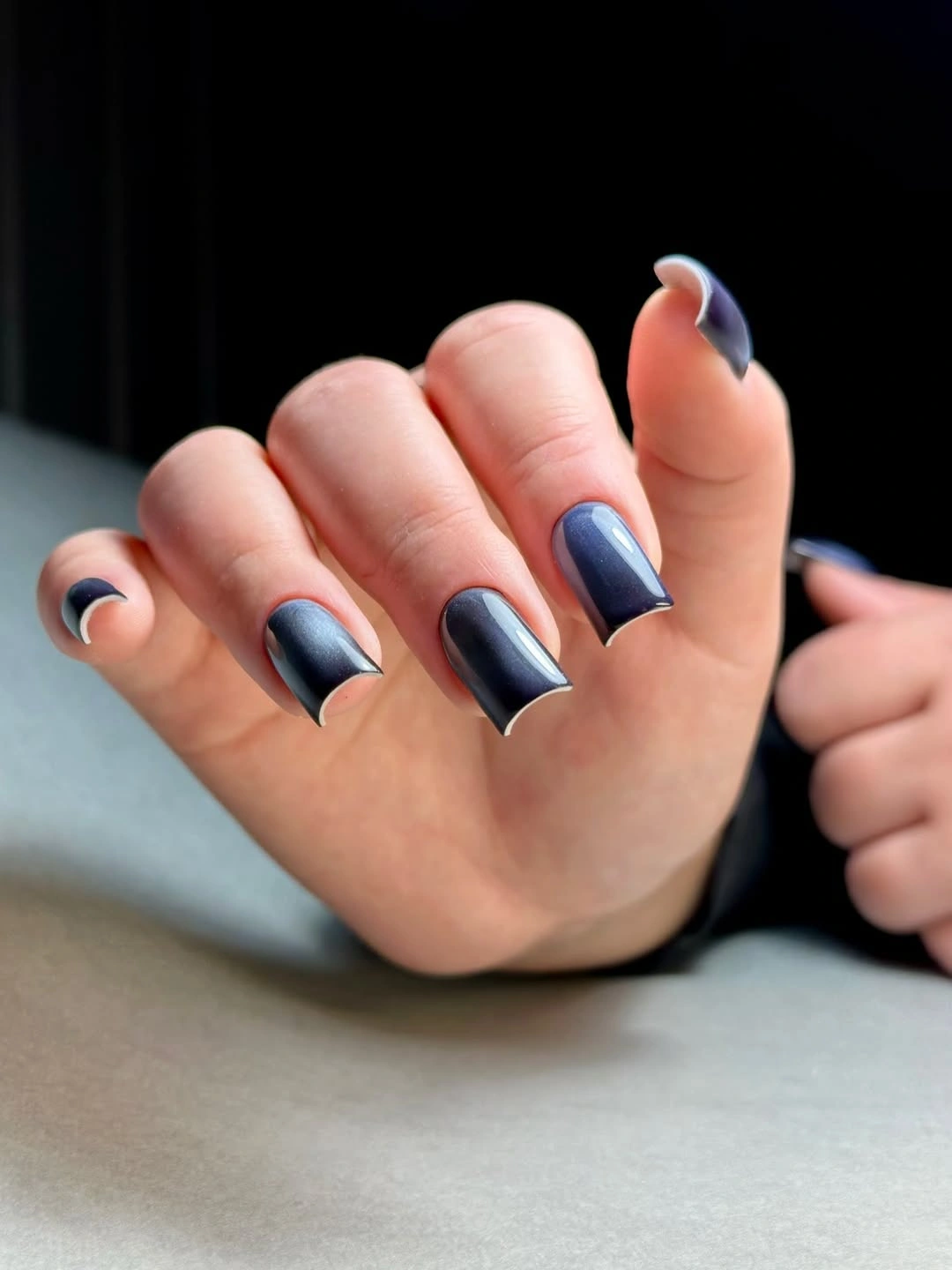 Short square blue nails with pale curved French-like edges