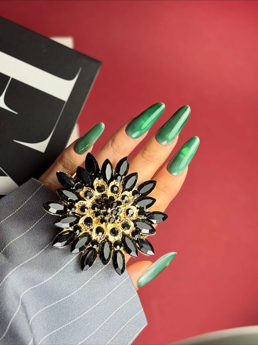 Long tapered green nails with vertical reflective glow