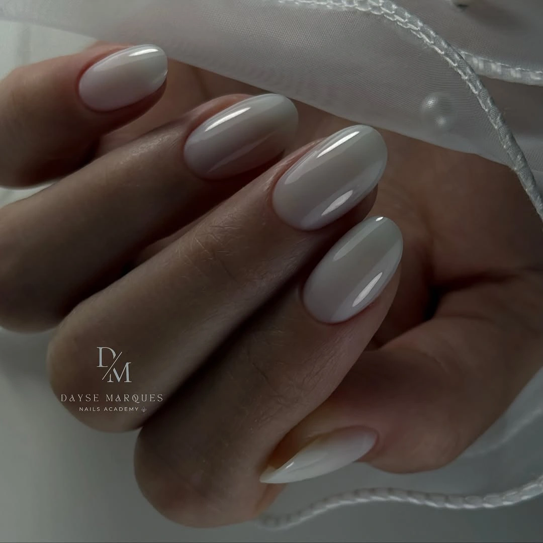Glossy milky off-white oval nails with rounded tips