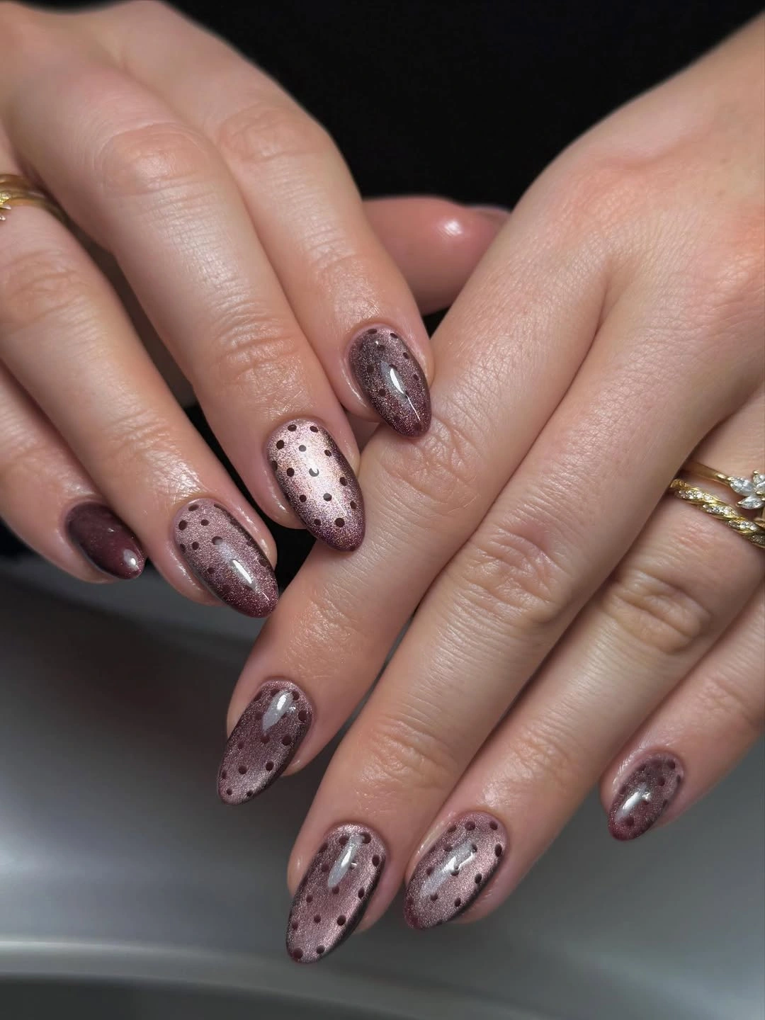 Mauve-brown shimmer nails with black dot pattern