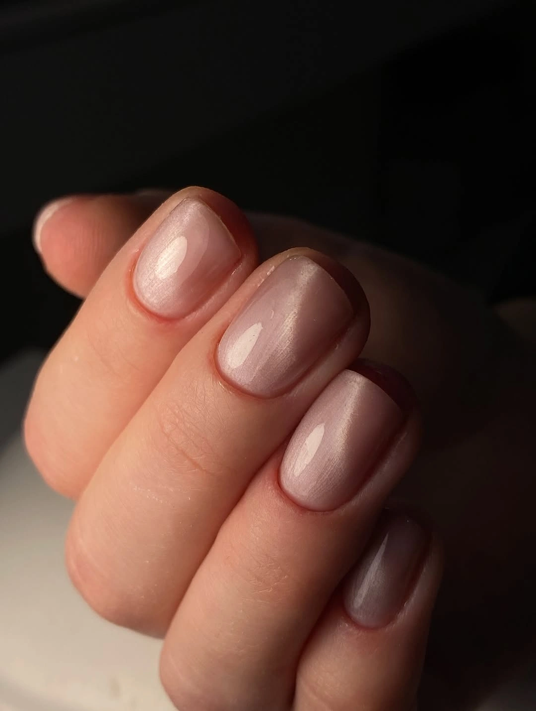 Very short rounded nails with sheer pale pink polish