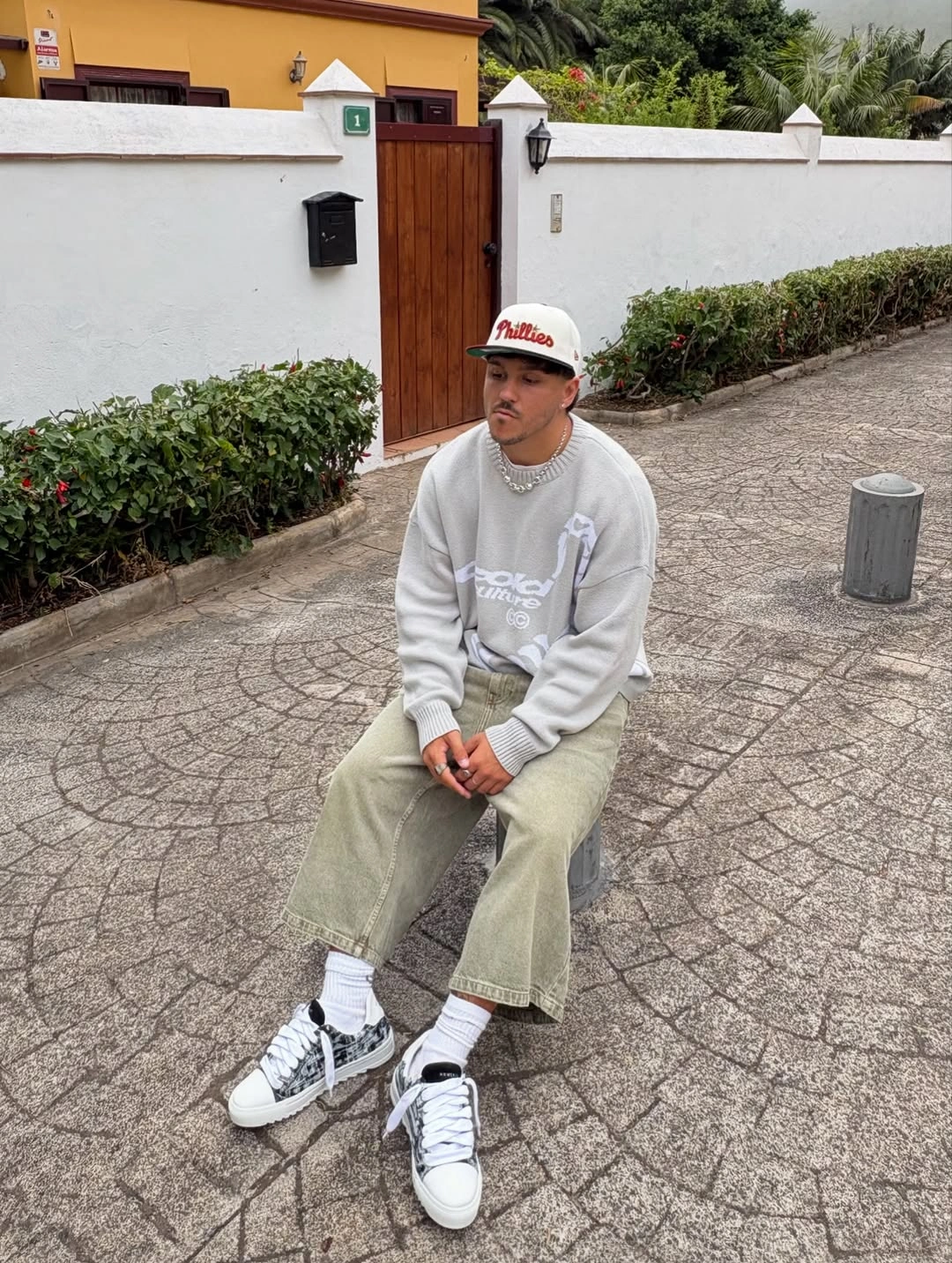Gray sweatshirt with wide olive trousers and white high-top sneakers