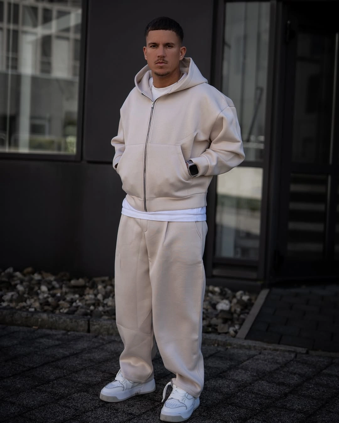 Cream hoodie with matching sweatpants and light sneakers