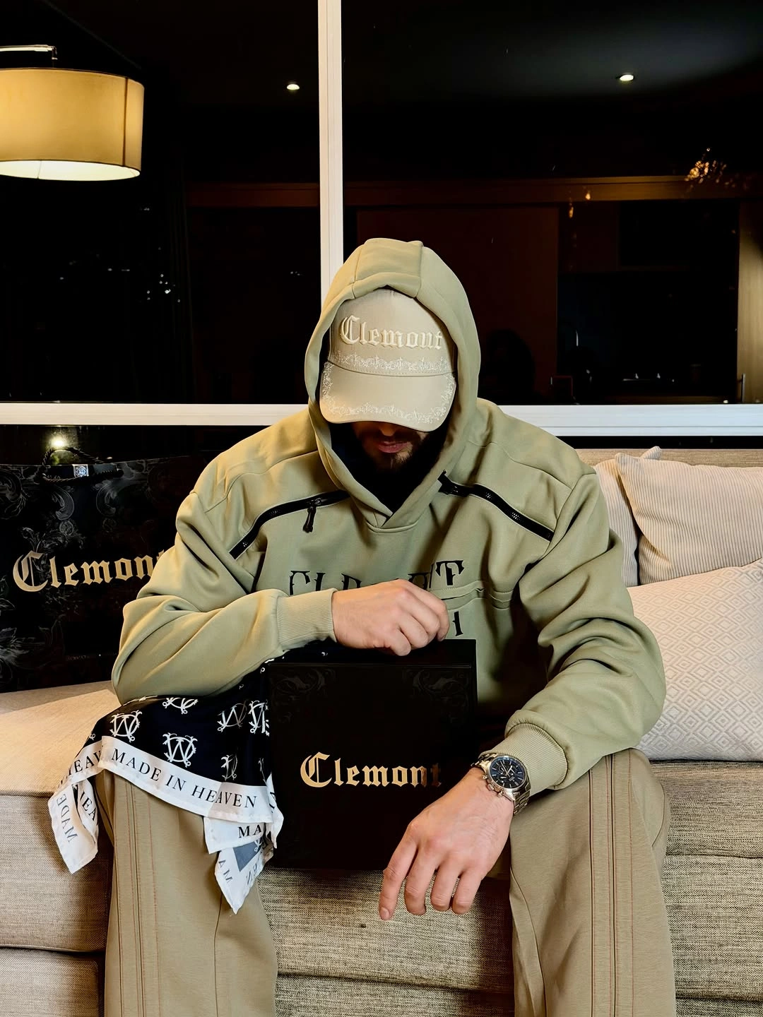 Dark sweatshirt with washed gray loose jeans, cap, and crossbody bag